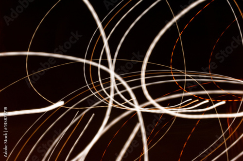 Bright light lines on dark background. the light trails on the street captured with long exposure shot