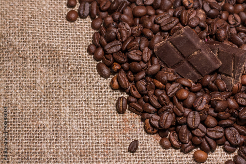 Broken slices of chocolate and coffee beans. Broken slices of chocolate and coffee beans.