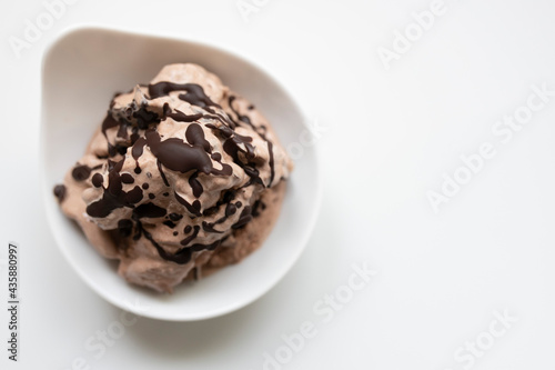 selbstgemachtes Schokoladeneis mit Ahornsirup und Schokoladenstückchen, Hintergrund weiß