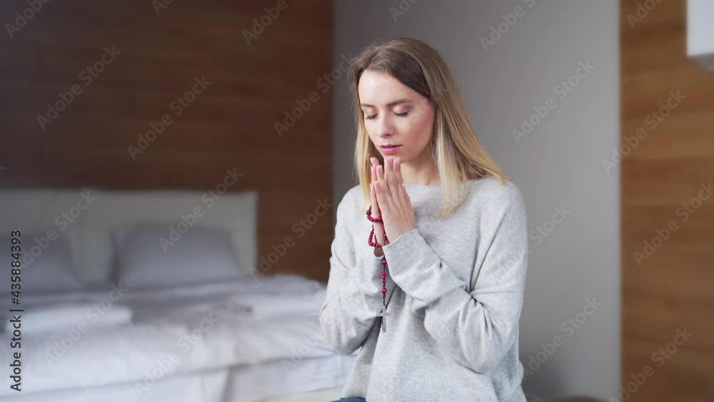 portrait young girl or woman sincerely praying on rosary at home. Prayer of repentance. Female believer with closed eyes and a beads in his hands. Christian or Orthodox Catholic in daily prayers portrait young girl or woman sincerely praying on rosary at home. Prayer of repentance. Female believer with closed eyes and a beads in his hands. Christian or Orthodox Catholic in daily prayers