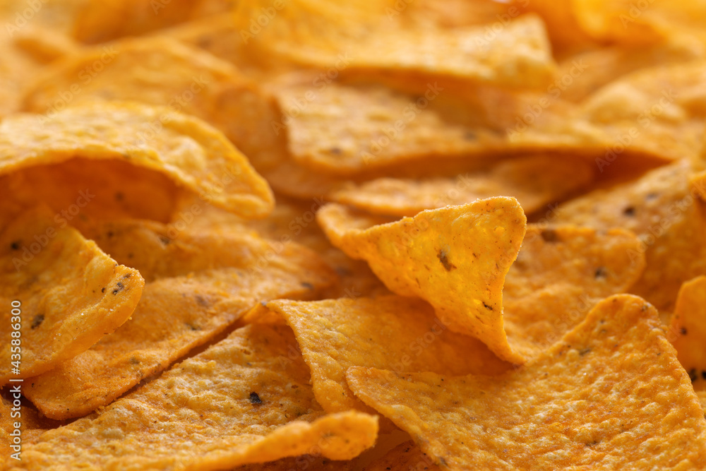 Delicious corn chips background. Traditional mexican tortilla snacks with spices. Macro image of crispy nachos for banner. Closeup Delicious corn chips background. Traditional mexican tortilla snacks with spices. Macro image of crispy nachos for banner. Closeup