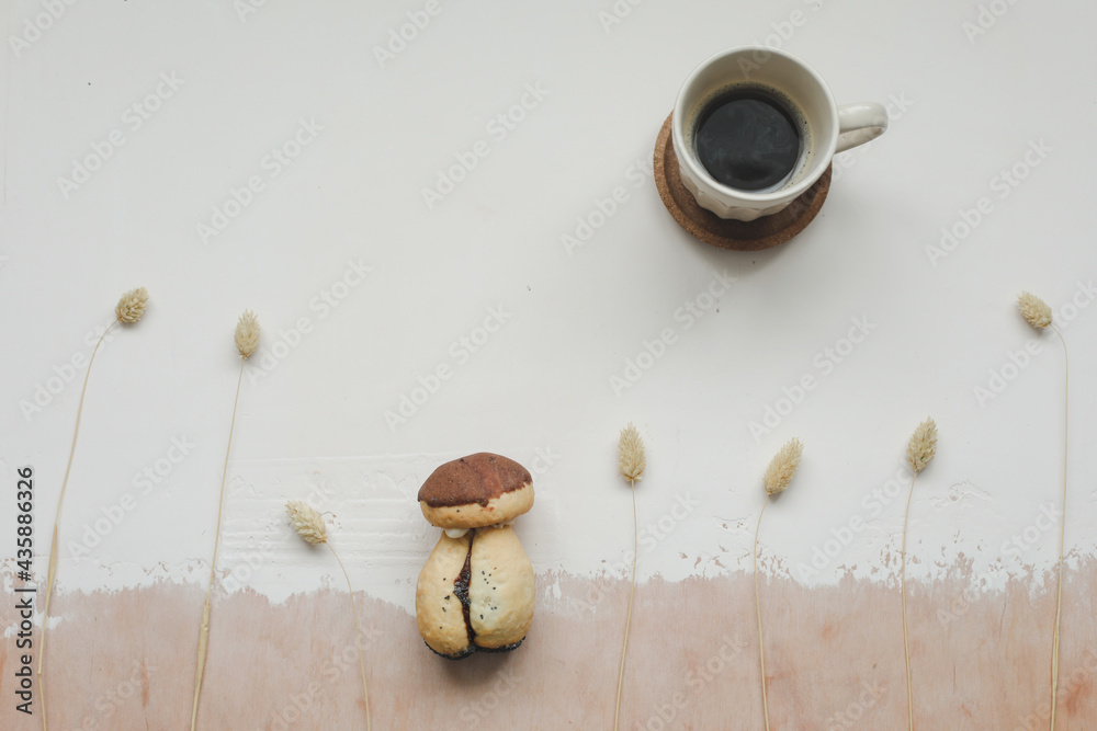 Cake mushroom and a cup of hot coffee on the table top view. Appetizing cake. Cookie and coffee Cake mushroom and a cup of hot coffee on the table top view. Appetizing cake. Cookie and coffee