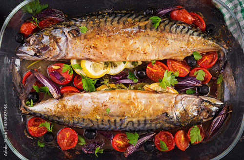 Baked mackerel with herbs and lemon and  vegetables. Healthy dinner. Top view, flat lay