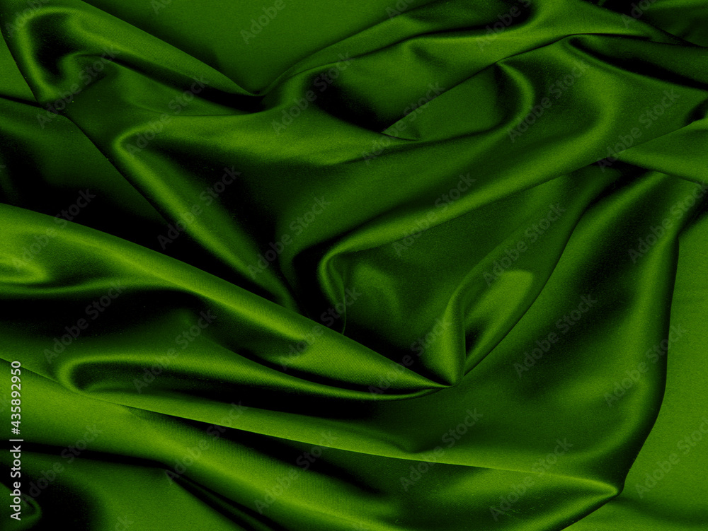Green silk folds texture. Abstract background. Green silk folds texture. Abstract background.