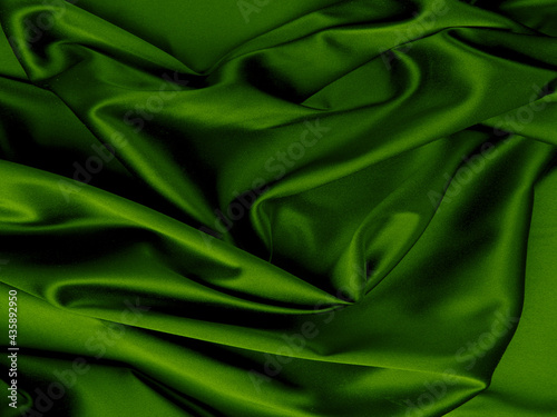 Green silk folds texture. Abstract background. 
