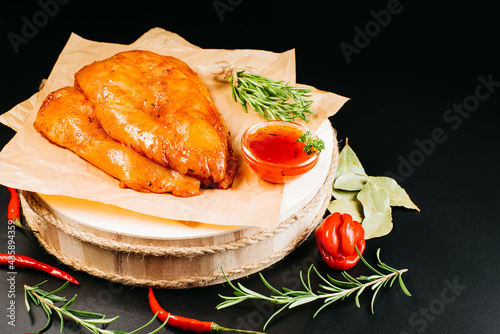 Chicken fillet in red marinade with spices.Marinated Chicken Breast with spices and rosemary. photo