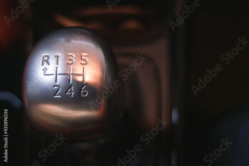 Close-up of the gear shift lever of a car with six speeds. 