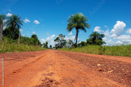 Dirt ground road crossing farm