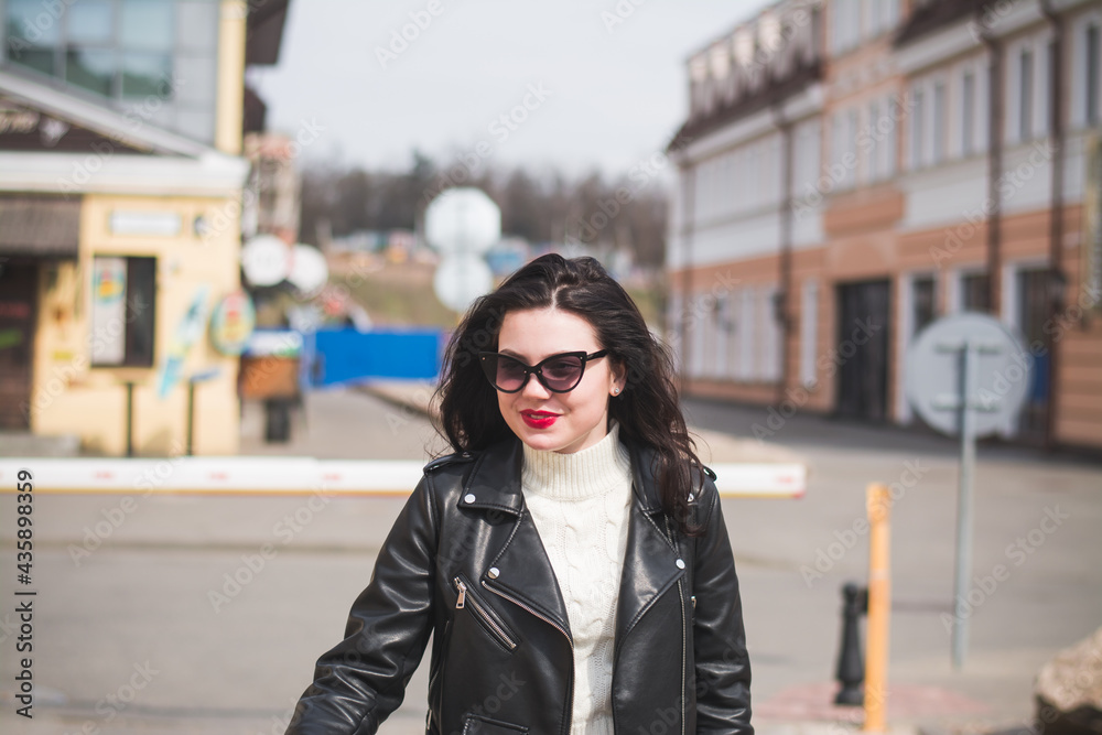 A beautiful young brunette hipster girl on the street of her city A beautiful young brunette hipster girl on the street of her city