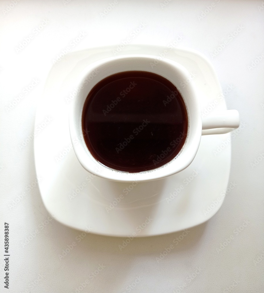 White cup with black coffee. Flat lay White cup with black coffee. Flat lay