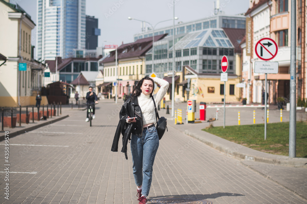 A beautiful young brunette hipster girl on the street of her city