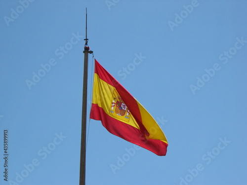 Spanish flag on a blue sky background. Alicante Spain