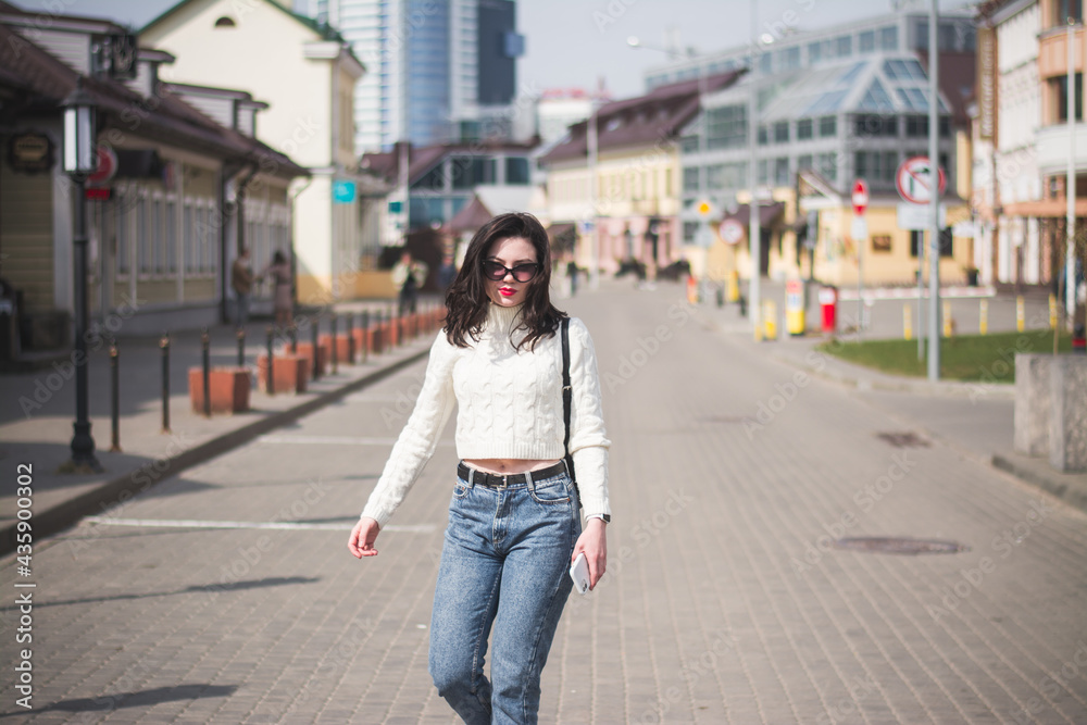 A beautiful young brunette hipster girl on the street of her city