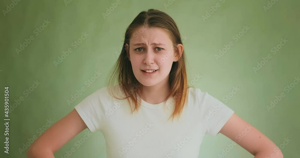 Strange woman shrugs sarcastically posing for studio camera Strange woman shrugs sarcastically posing for studio camera