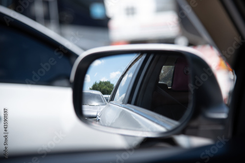 Close up of car mirror with reflection of a beautiful landscape. © czchampz