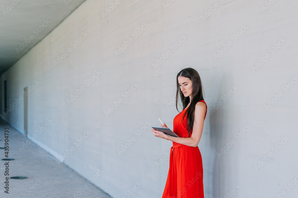 Young business woman writing in a tablet. Young business woman writing in a tablet.