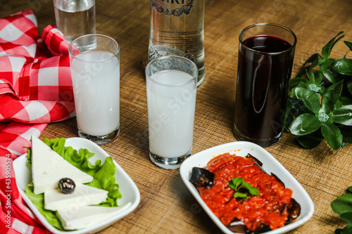 National Turkish alcoholic drink Raki and appetiser on table photo