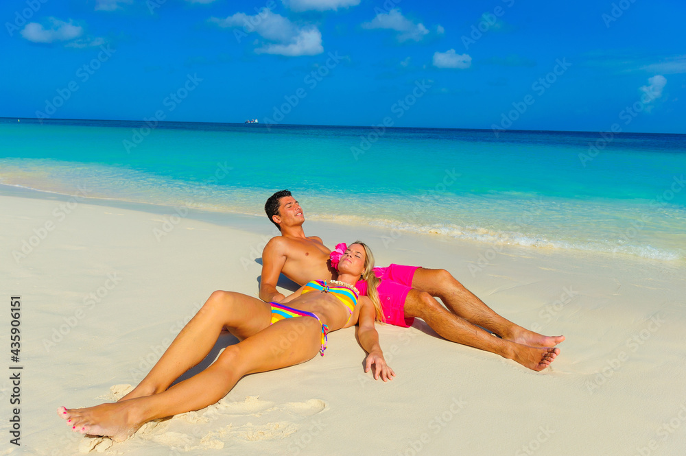 Couple at the beach, relaxing, sitting on the beach 