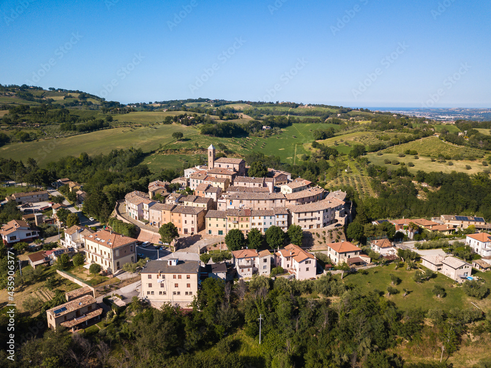 Italy, May 2021. Aerial view of the medieval village of Serrungarina in the province of Pesaro and Urbino in the Marche region. You can also see the green hills around.