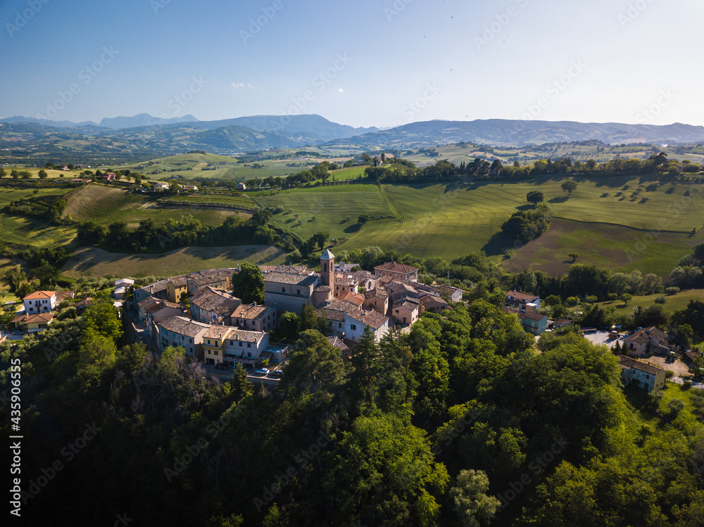 Italy, May 2021. Aerial view of the medieval village of Serrungarina in the province of Pesaro and Urbino in the Marche region. You can also see the green hills around. Italy, May 2021. Aerial view of the medieval village of Serrungarina in the province of Pesaro and Urbino in the Marche region. You can also see the green hills around.