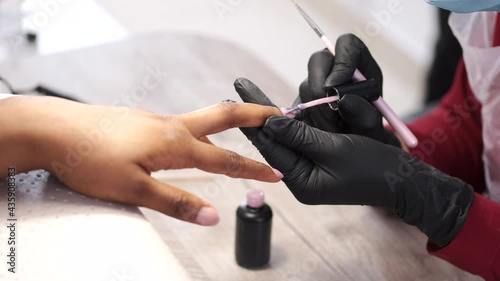 African girl doing manicure in a beauty salon photo