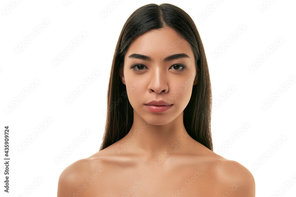Young Asian woman with clean radiant healthy skin isolated on white background. Facial skin care concept, cosmetology, spa. Young Asian woman with clean radiant healthy skin isolated on white background. Facial skin care concept, cosmetology, spa.