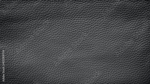 Close-up of detailed dark gray or black faux leather surface. High resolution full frame textured background.