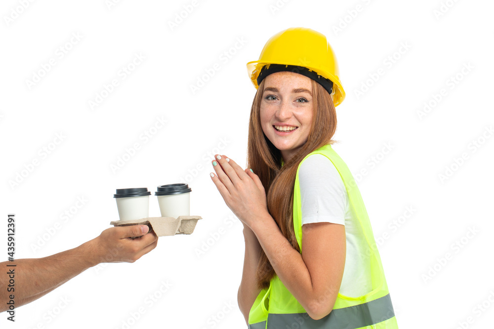 Young beautiful red hair model in vest and helmet receive coffee order Young beautiful red hair model in vest and helmet receive coffee order
