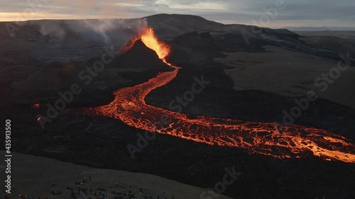 Onlookers watch volcano eruption near Fagradalsfjall in Iceland. Aerial reverse  photo