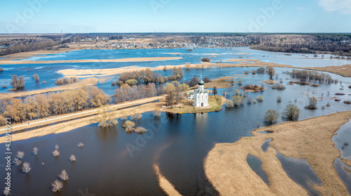 Spring flood of the river into the fields. The Church of the Intercession on the Nerl River (Pokrova na Nerli) aerial view from drone, included in the UNESCO. Vladimir region, Russia.