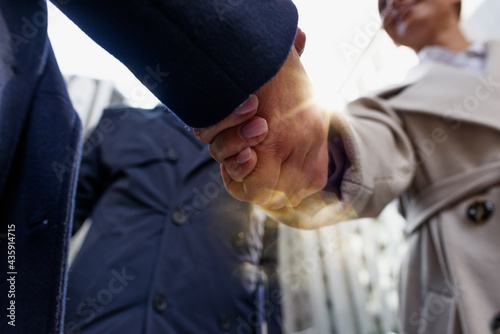 Handshaking business person in office as teamwork and partnership.