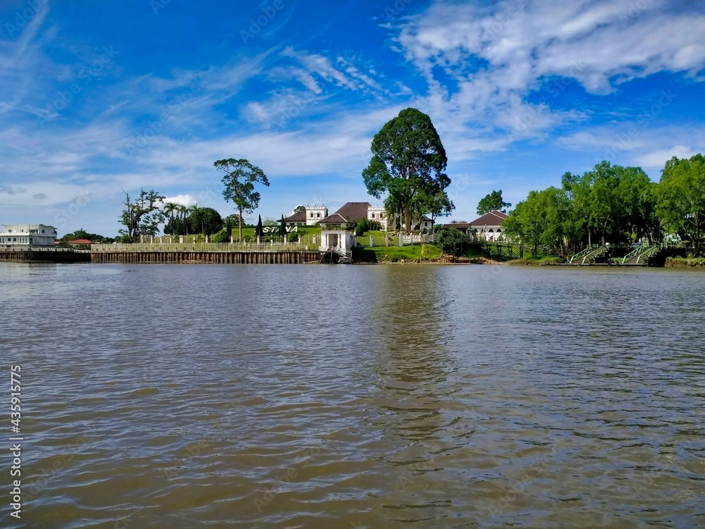 View of The Astana and Kuching City from the river. City Waterfront. Borneo Island. Sarawak. Malaysia. South-East Asia View of The Astana and Kuching City from the river. City Waterfront. Borneo Island. Sarawak. Malaysia. South-East Asia