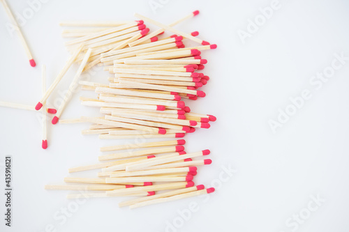 Long matches with a red head on a white background.