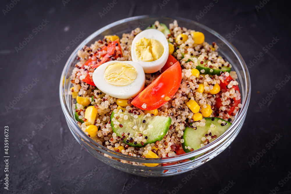 bowl of healthy quinoa with vegetables on a dark rustic background bowl of healthy quinoa with vegetables on a dark rustic background