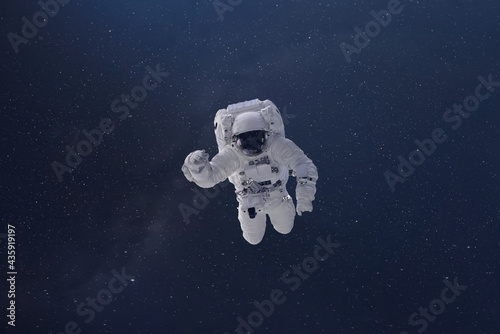 cosmonaut fly in the outer space with stars and galaxy background with a light beam. elements of this image furnished by nasa © Mihail