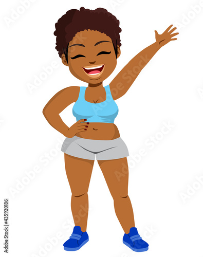 Happy smiling sporty black plus size body positive woman raising arm up wearing blue tank top and grey shorts