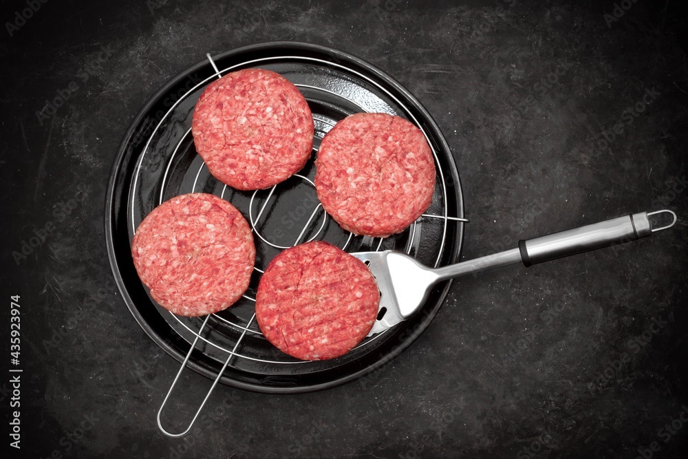 Grill Barbecue Grate with Raw Beef Hamburger Patties. Ground Beef Patties for Grilling and