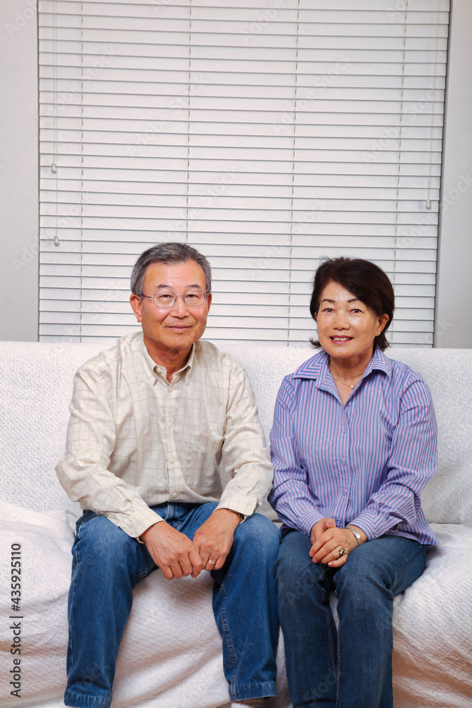 Japanese senior couple smiling at the camera Japanese senior couple smiling at the camera