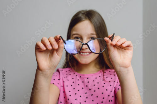 Portrait of a cute beautiful 8 year old girl with glasses