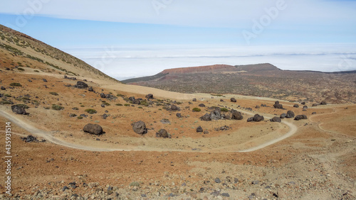 Frozen lava rocks called Teide-Eggs in front of a hiking path on way up to Pico de Teide  Tenerife  Spain