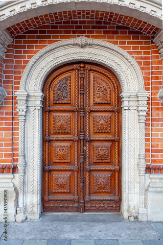 Carved wooden door of an ancient building with an ornate pattern