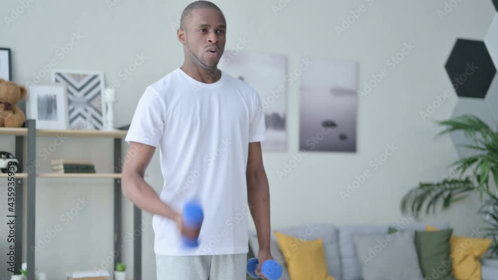 Sporty African Man Working out with Dumbbells at Home Sporty African Man Working out with Dumbbells at Home