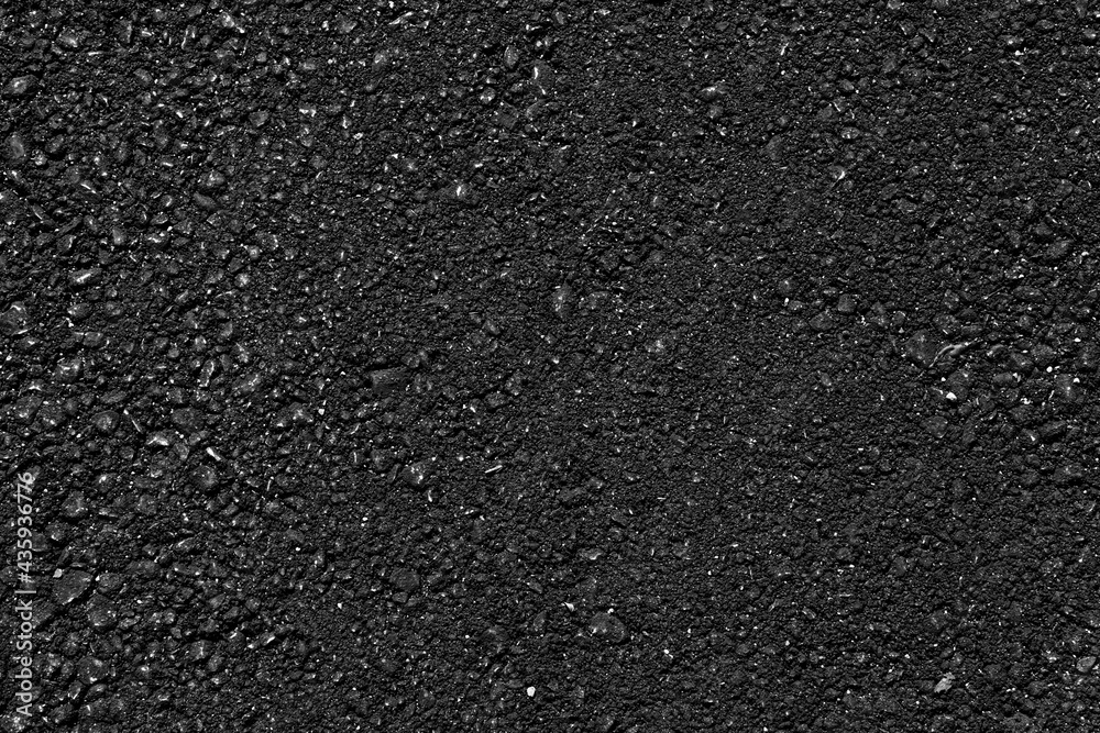Asphalt pavement with a beautiful black texture lit by a soft light ...