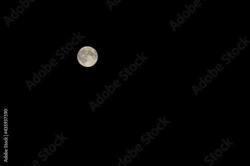 Fotografía A full moon at its largest size called super moon at a clear dark summer night with no clouds with a negative copy space, Cairo, Egypt