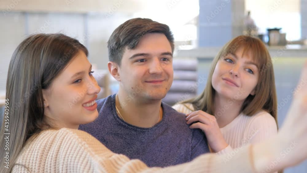 A young group of friends take selfies in a restaurant, laugh in a pizzeria A young group of friends take selfies in a restaurant, laugh in a pizzeria