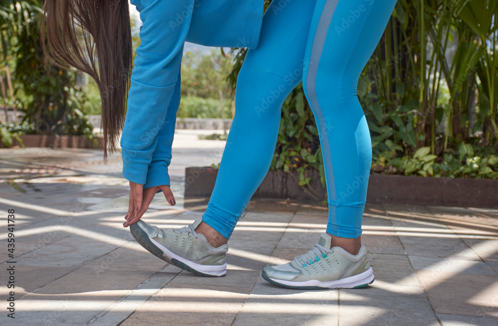 Young man touching tip toe blue pants side balance cut to mid
