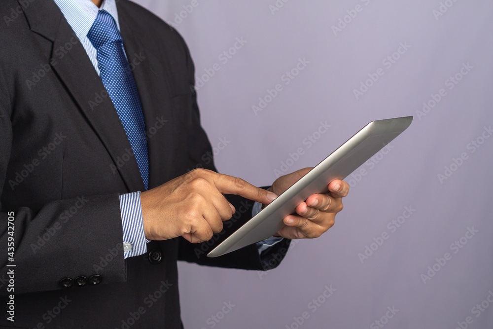 Side view of a businessman using a tablet. Stock market investments funds and digital assets. Business finance and investment concept