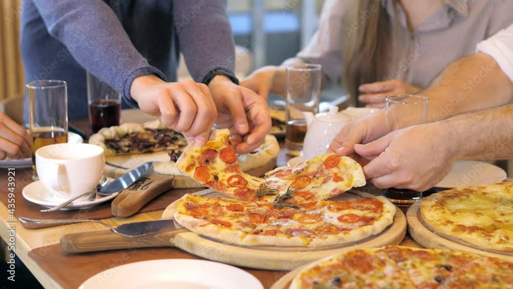 A young group of friends socialize, eat pizza, colleagues hang out in a cafe A young group of friends socialize, eat pizza, colleagues hang out in a cafe