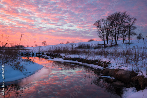 Fototapeta Naklejka Na Ścianę i Meble -  A colorful sunset sky over a quiet winter landscape.