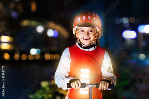 Safety on dark street. Kids reflective vest. photo